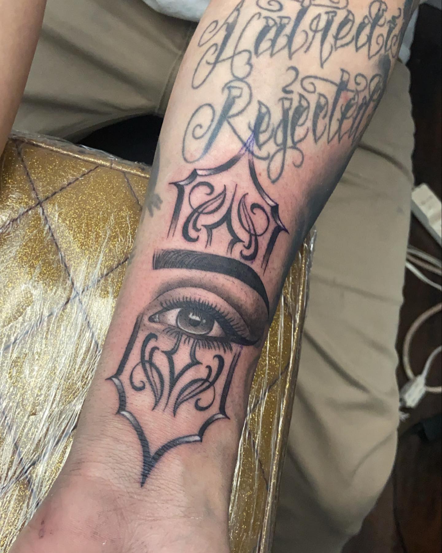 Eye with decorative frame geometric tattoo on the forearm by Bree Quirino