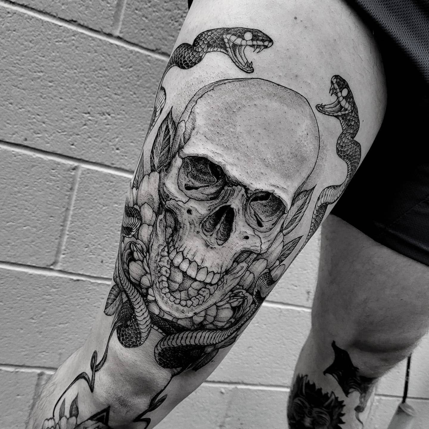 Skull with snakes realism tattoo on the forearm by Matthew Barnett