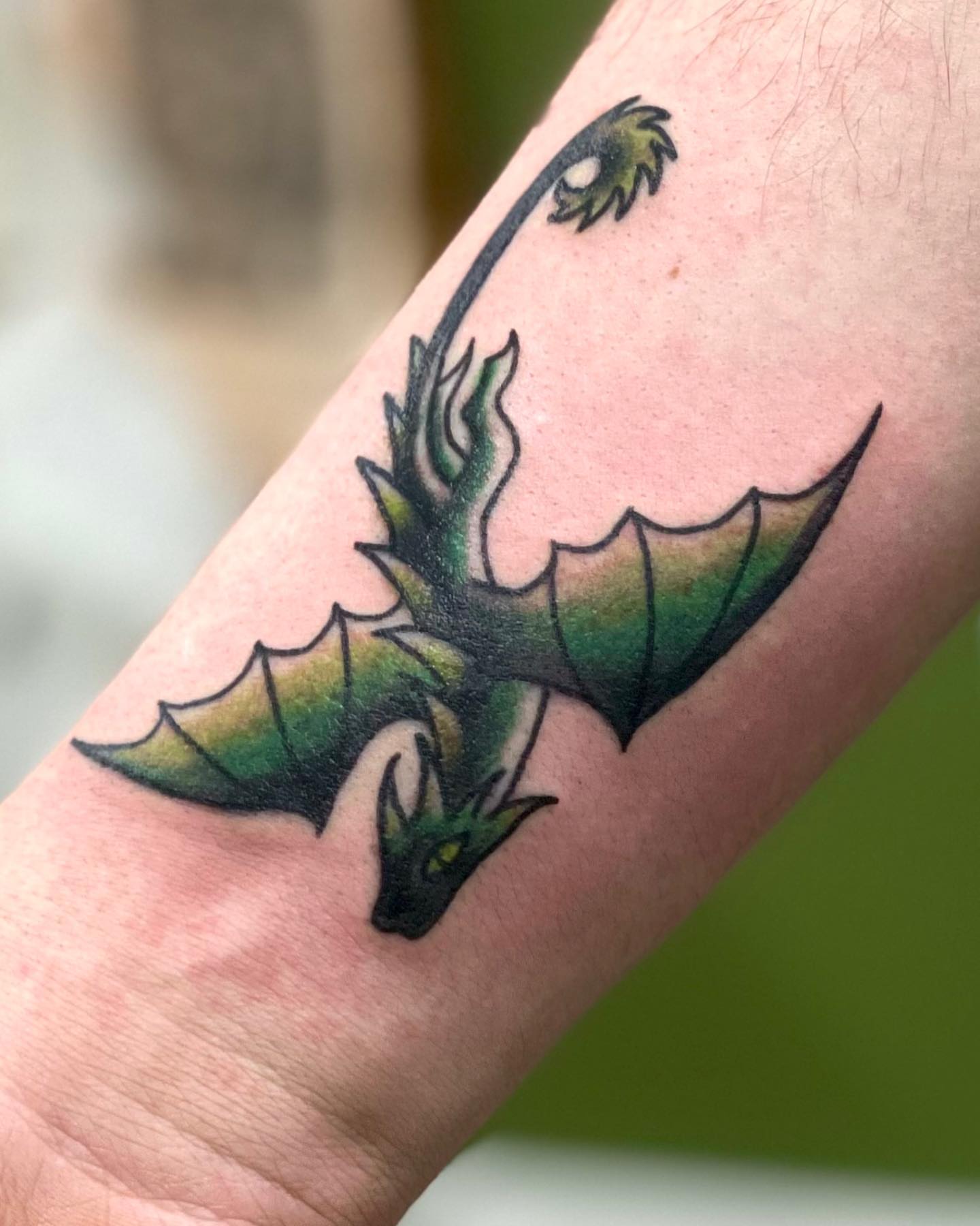 Dragon American traditional tattoo on the forearm by Erin Stephens