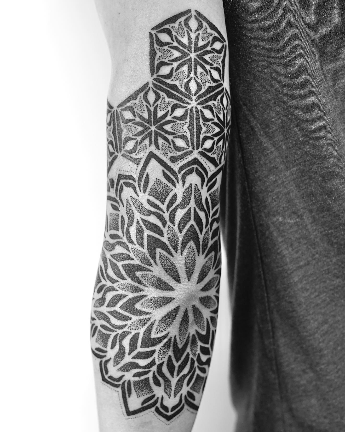Geometric pattern dotwork tattoo on the forearm by Ross Krandel