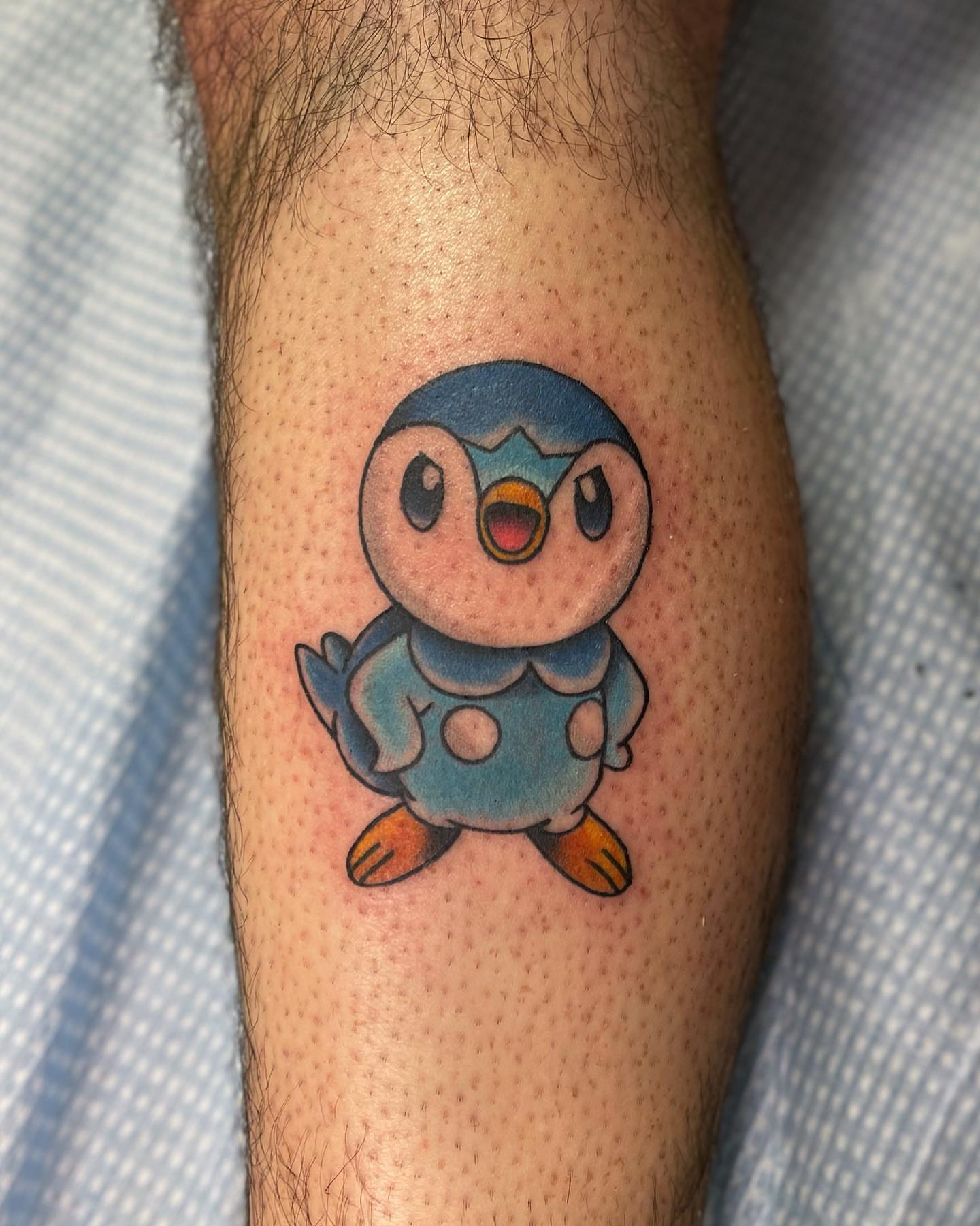 Penguin American traditional tattoo on the forearm by Jake Snoddy, Franklin, Tennessee