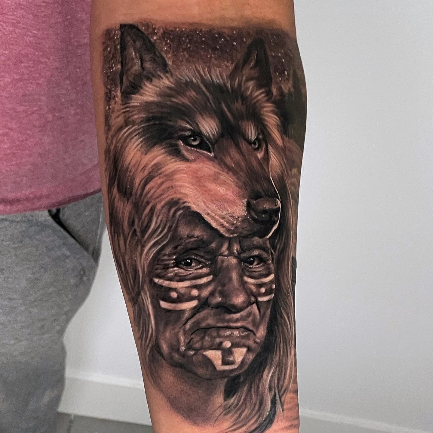 Wolf and native American man realism tattoo on the forearm by Rusty Dornhecker, Columbus, Ohio