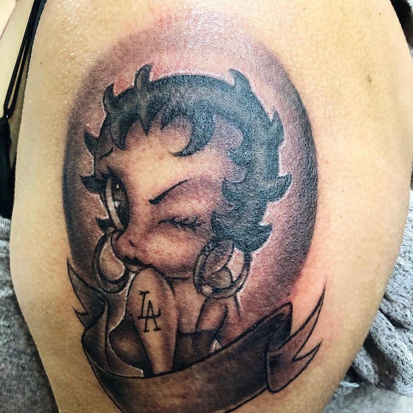Betty Boop American traditional tattoo on the shoulder by Visionary Tattoos
