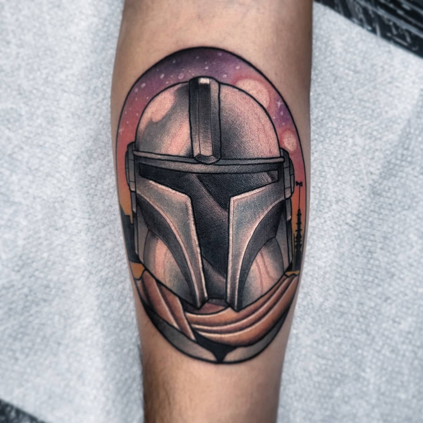 Mandalorian helmet realism tattoo on the forearm by TattoosbyPhatboi