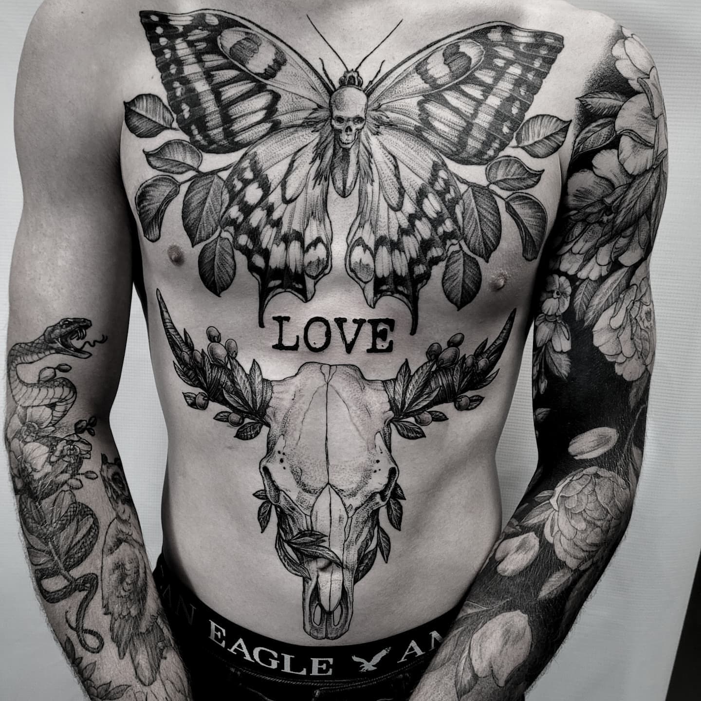 Butterfly and skull realism tattoo on the chest by Matthew Barnett