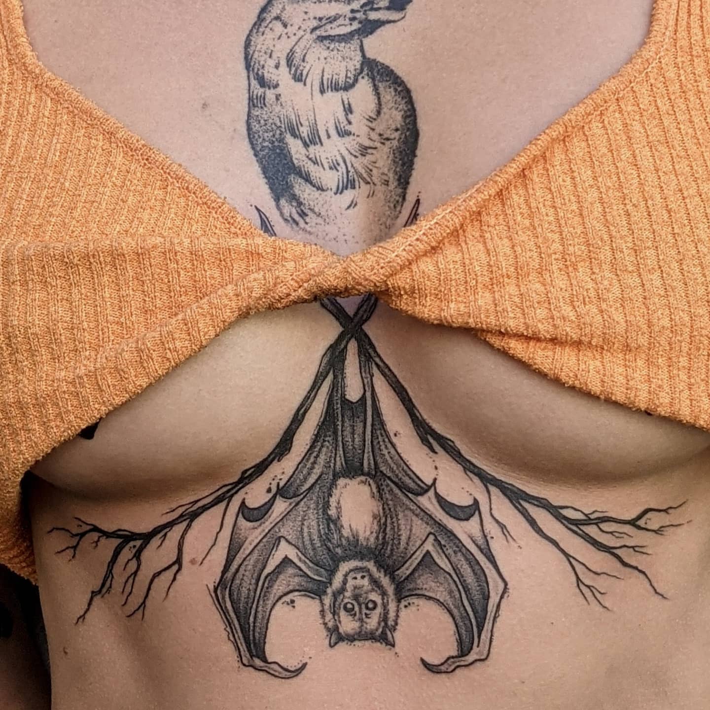 Bat black and grey tattoo on the chest by Gail Howard Perry III