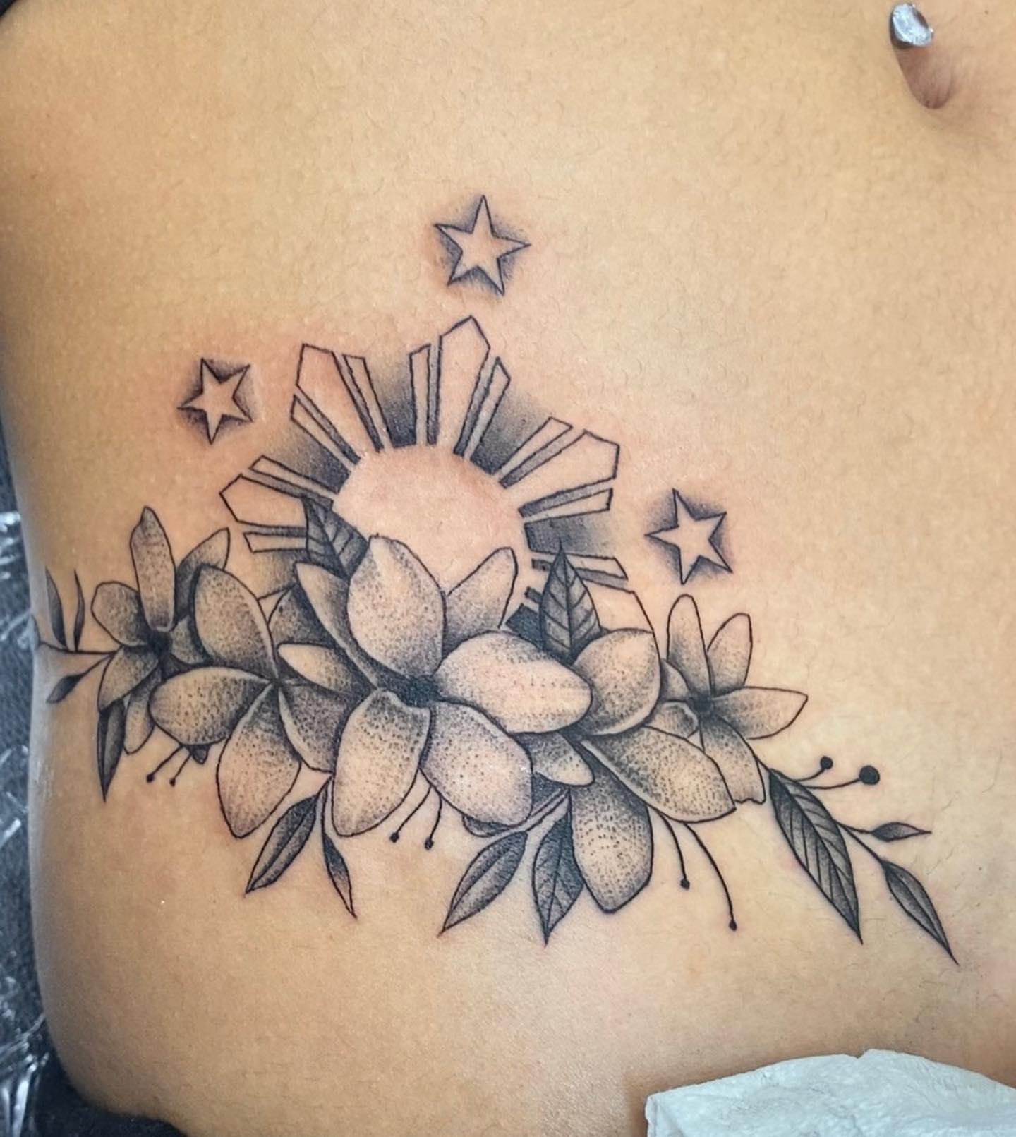 Flowers and sunburst dotwork tattoo on the ribs by Monique Ortiz, Mesa, Arizona