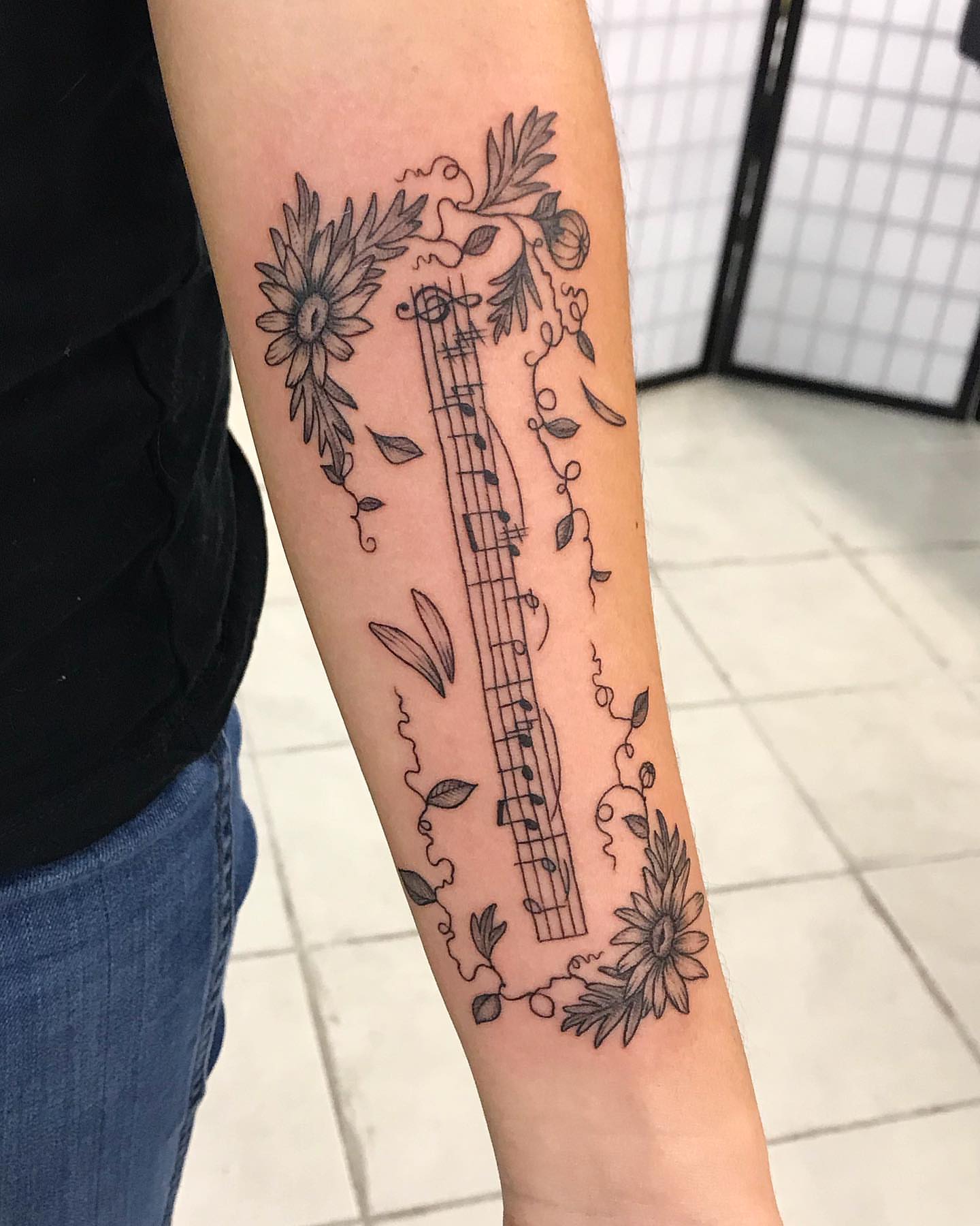 Music notes and floral elements black and grey tattoo on the forearm by 🍓secret k. - Austin Tattoo Artist