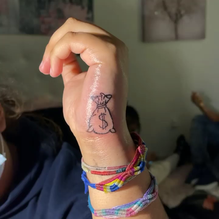 Money bag minimalist tattoo on the hand by InkByChing❤️🔥