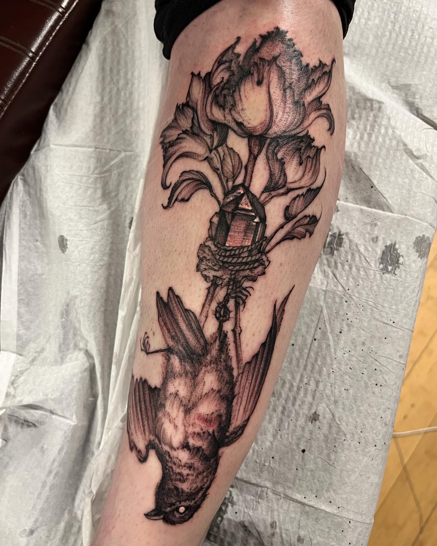 Bird and flower realism tattoo on the forearm by Sarah Spread
