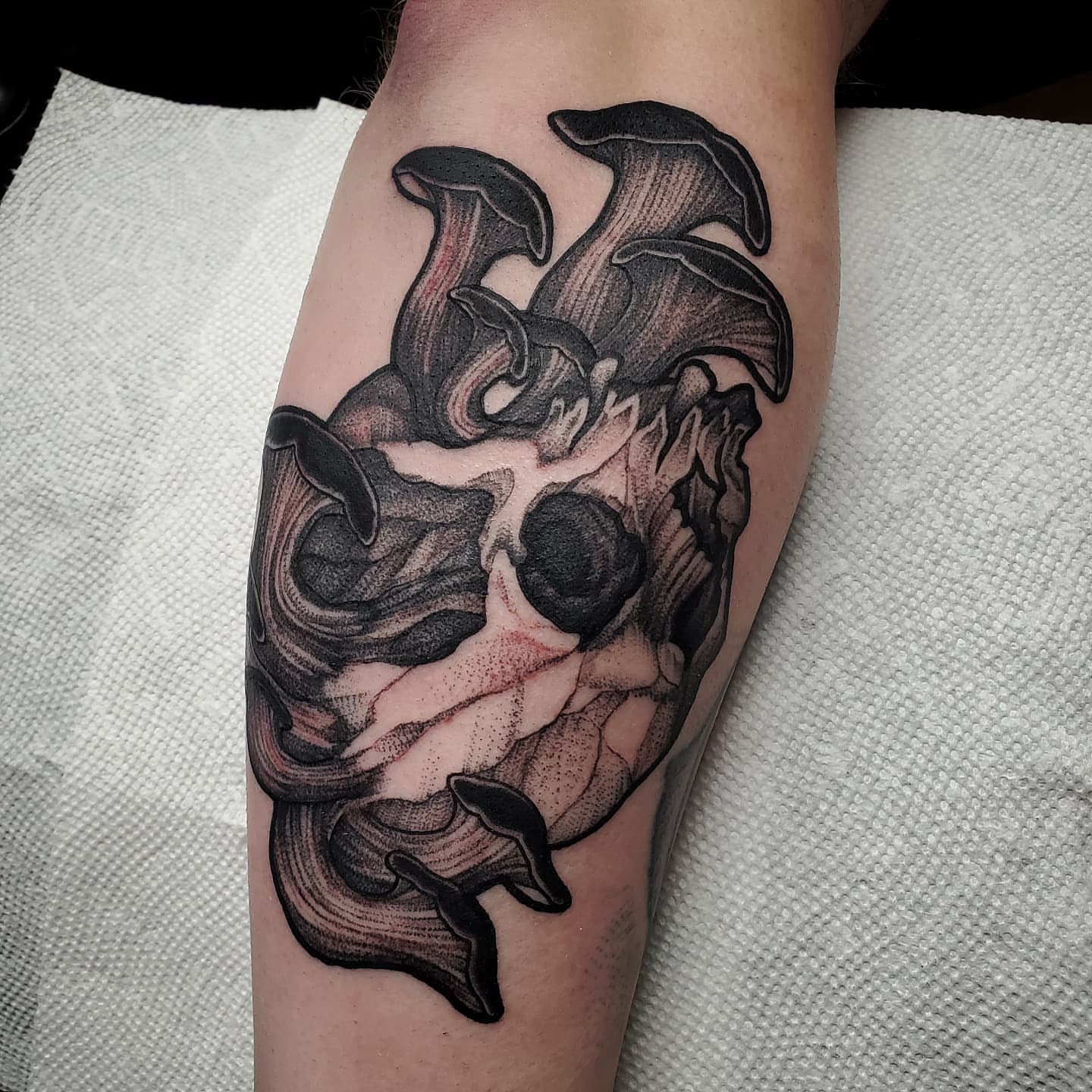 Skull with bat wings realism tattoo on the forearm by Kyle Black