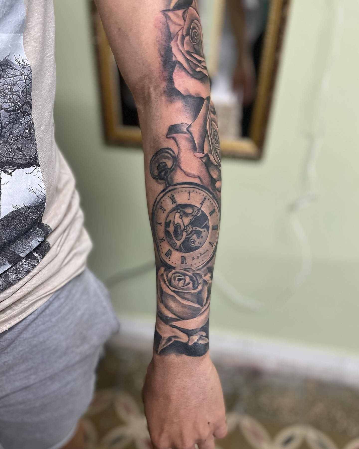 Pocket watch and roses realism tattoo on the forearm by Alfonso Duenas