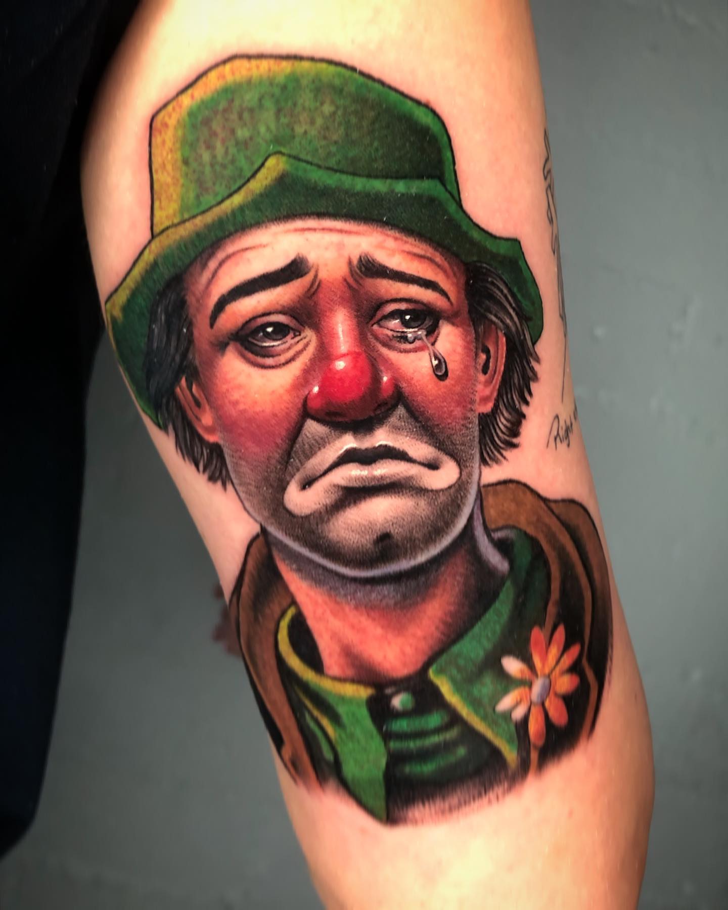 Sad clown realism tattoo on the forearm by David Torres