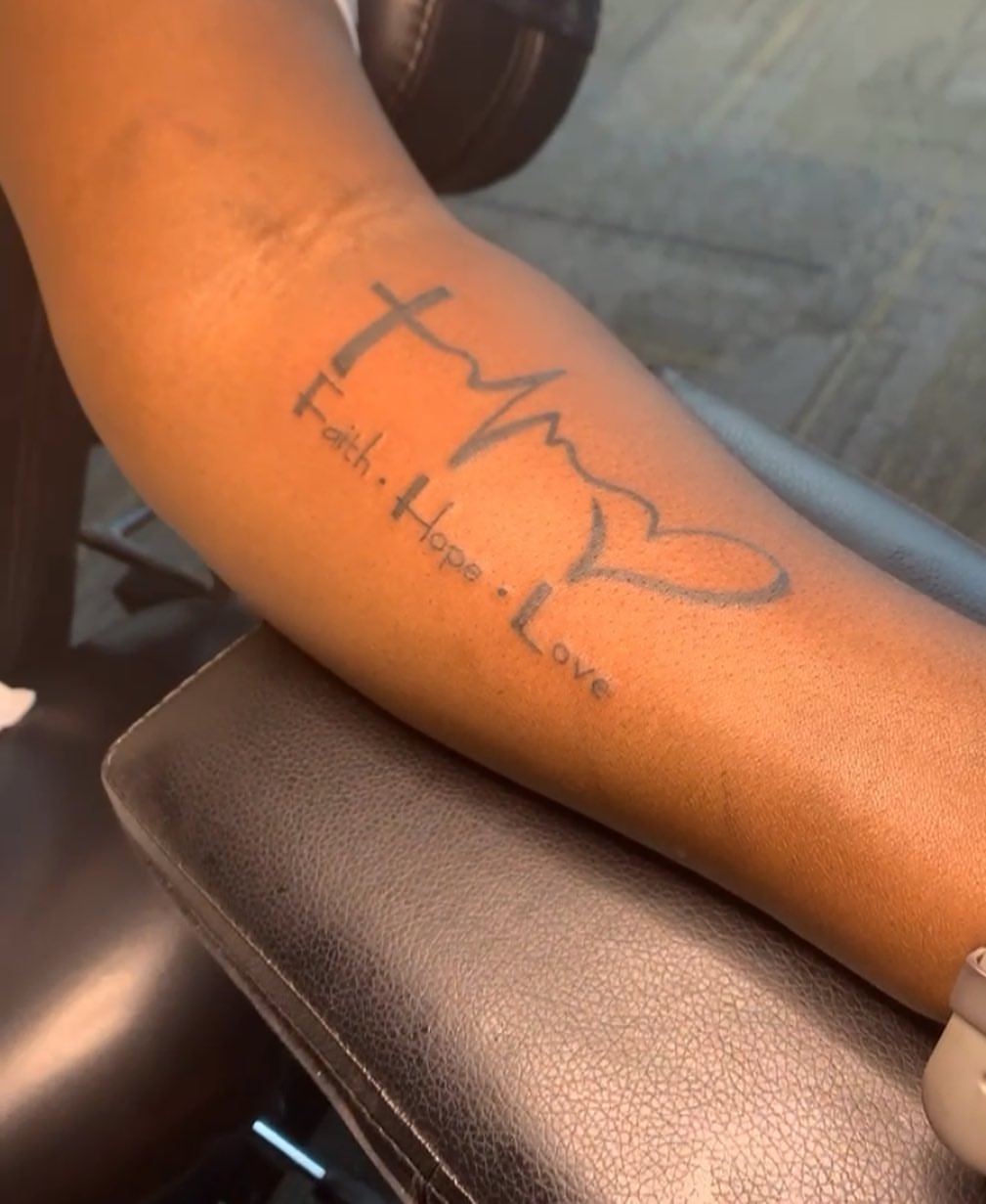 Cross and mountain silhouette fine line tattoo on the forearm by Wichita Tattoo