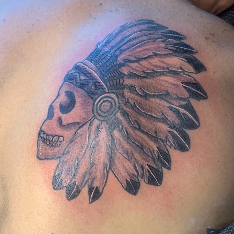 Skull headdress American traditional tattoo on the shoulder by Wichita Tattoo