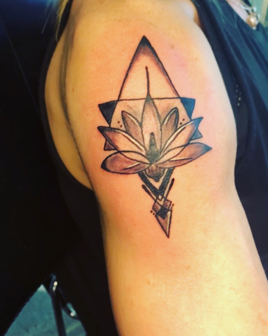 Lotus flower geometric tattoo on the shoulder by Wichita Tattoo