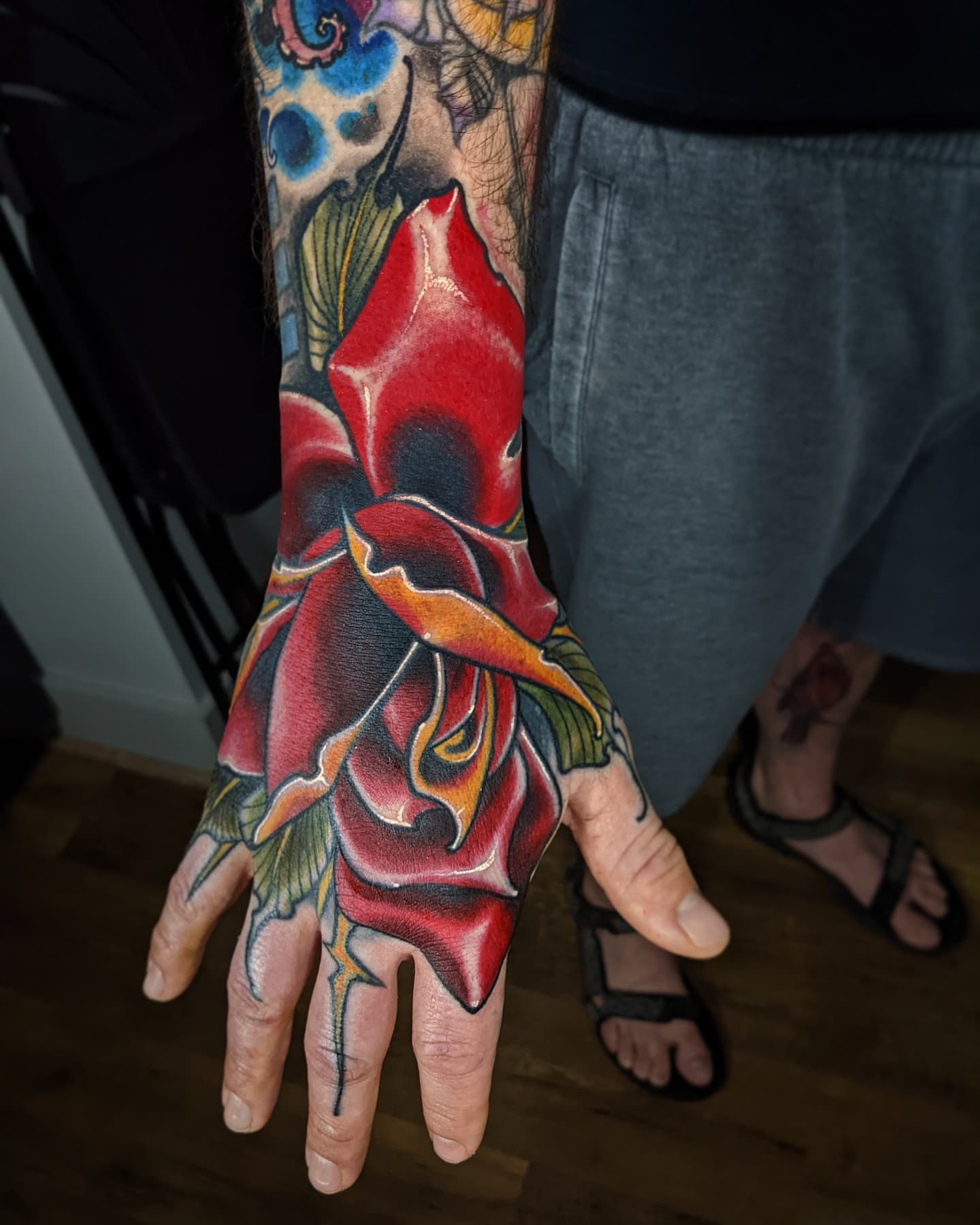 Red rose realism tattoo on the hand by Matt Driscoll