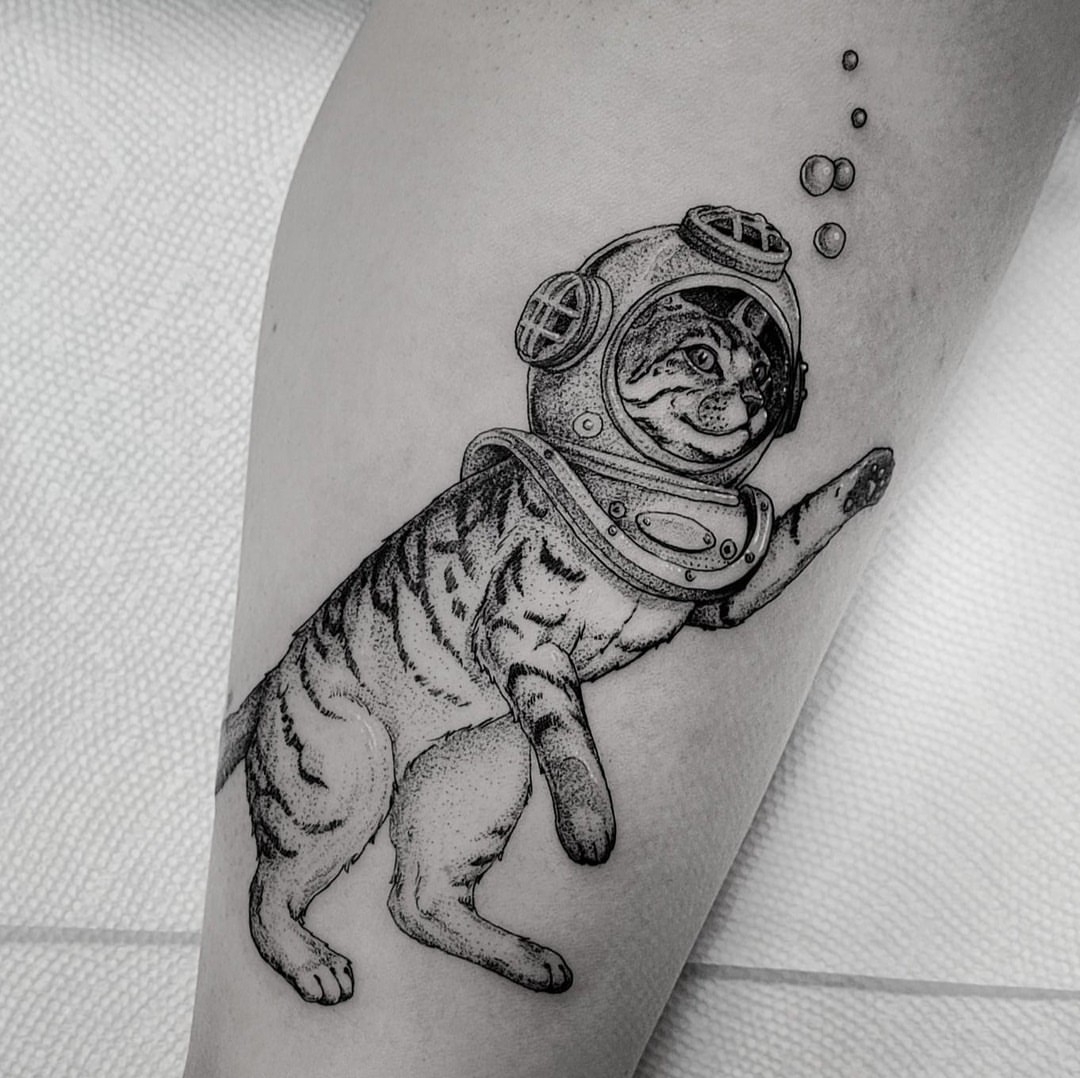 Cat wearing diving helmet dotwork tattoo on the forearm by Matthew Barnett