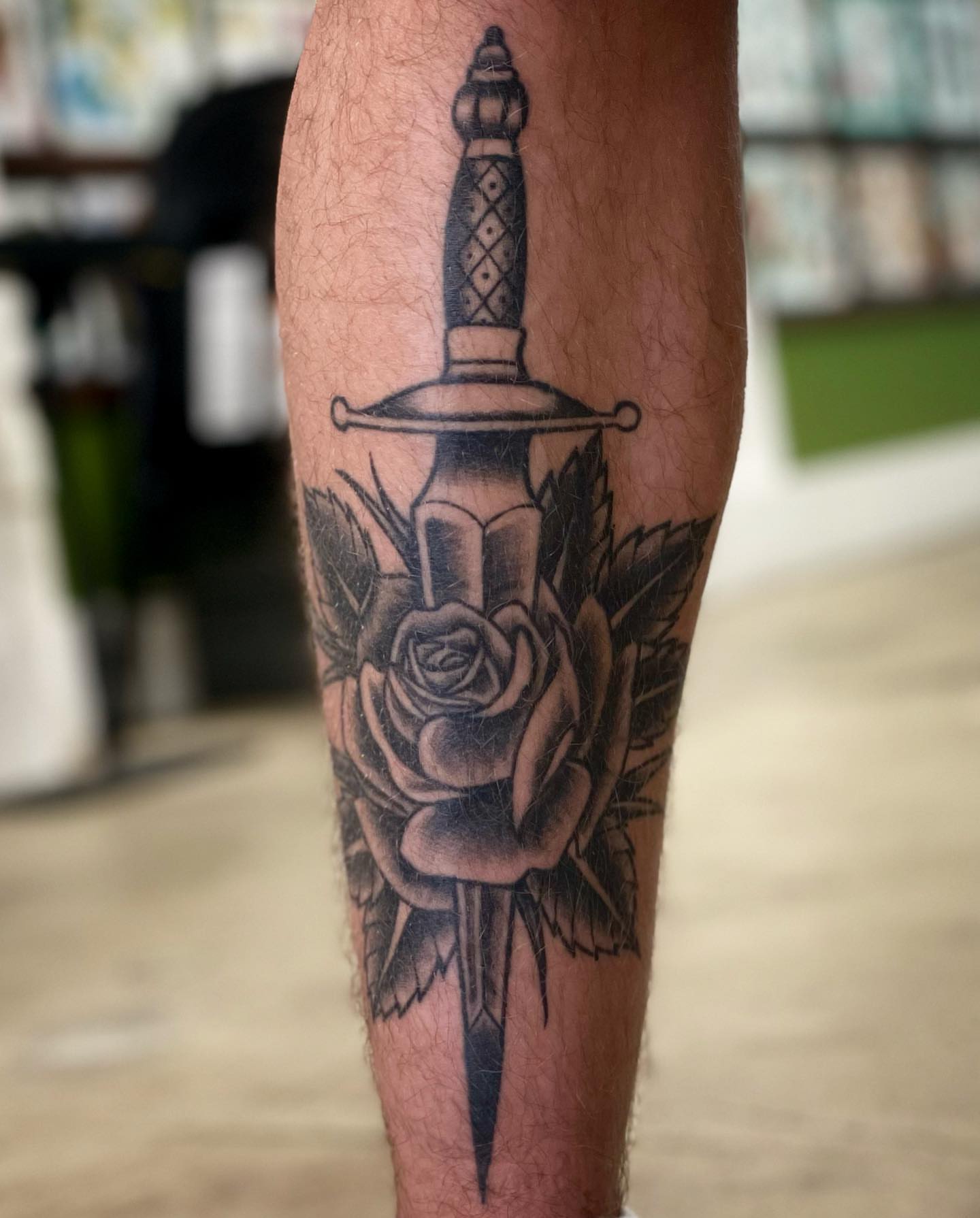 Sword and rose American traditional tattoo on the forearm by Erin Stephens
