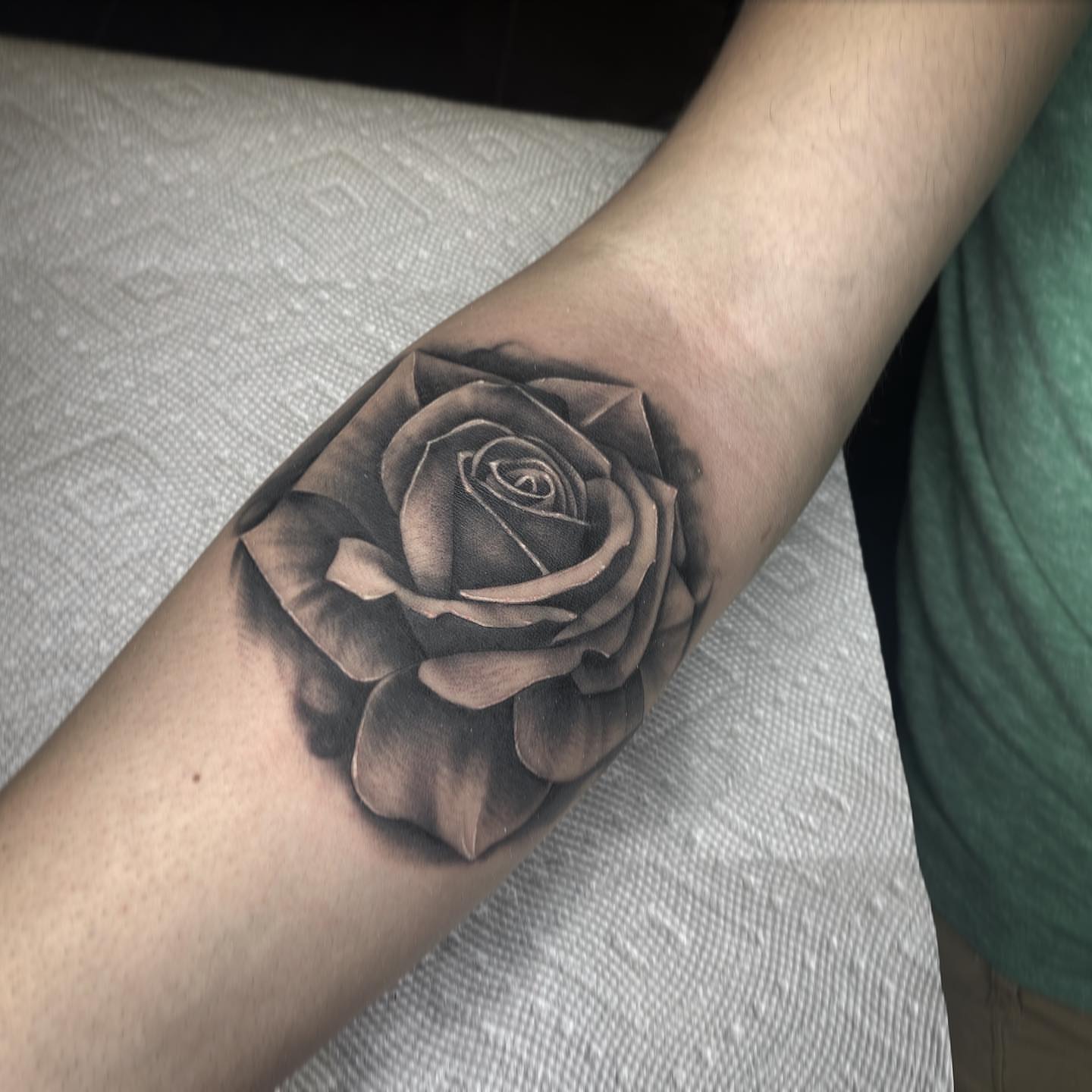 Rose black and grey tattoo on the forearm by Amber