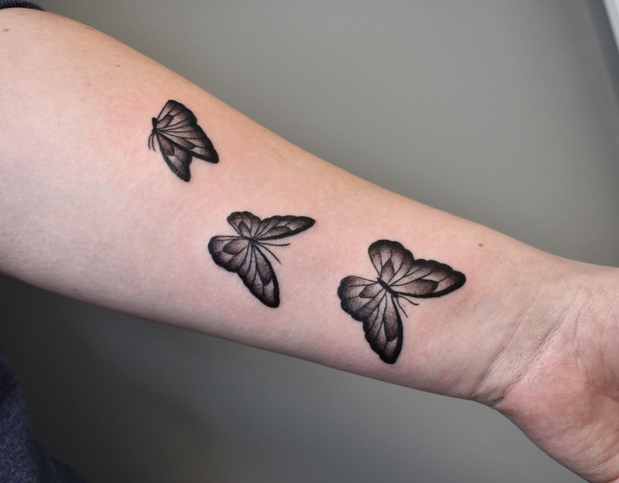 Butterflies black and grey tattoo on the forearm by Jenn ★ Reid
