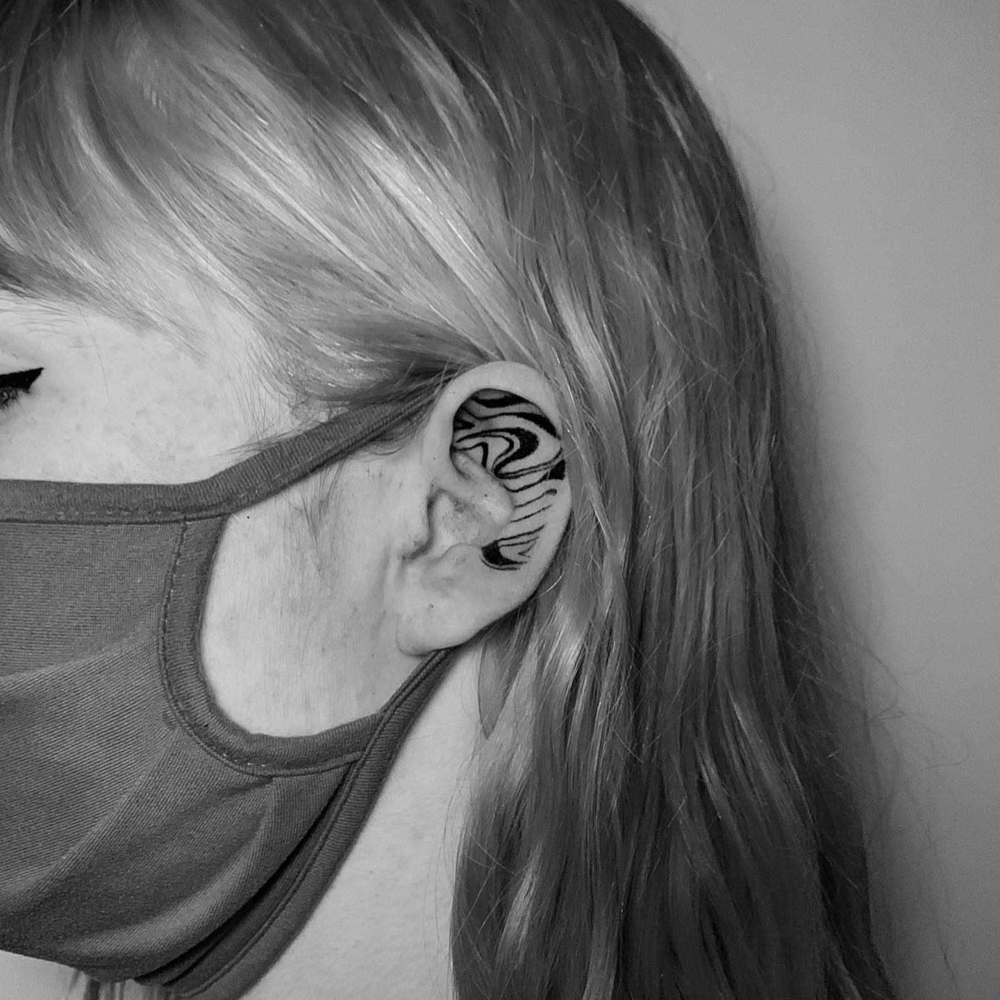 Ear black and grey tattoo on the head by Megan McKee Tattoo Artist