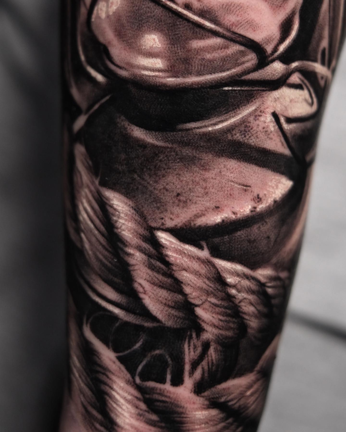 Wings and armor realism tattoo on the forearm by Anton Martiushev