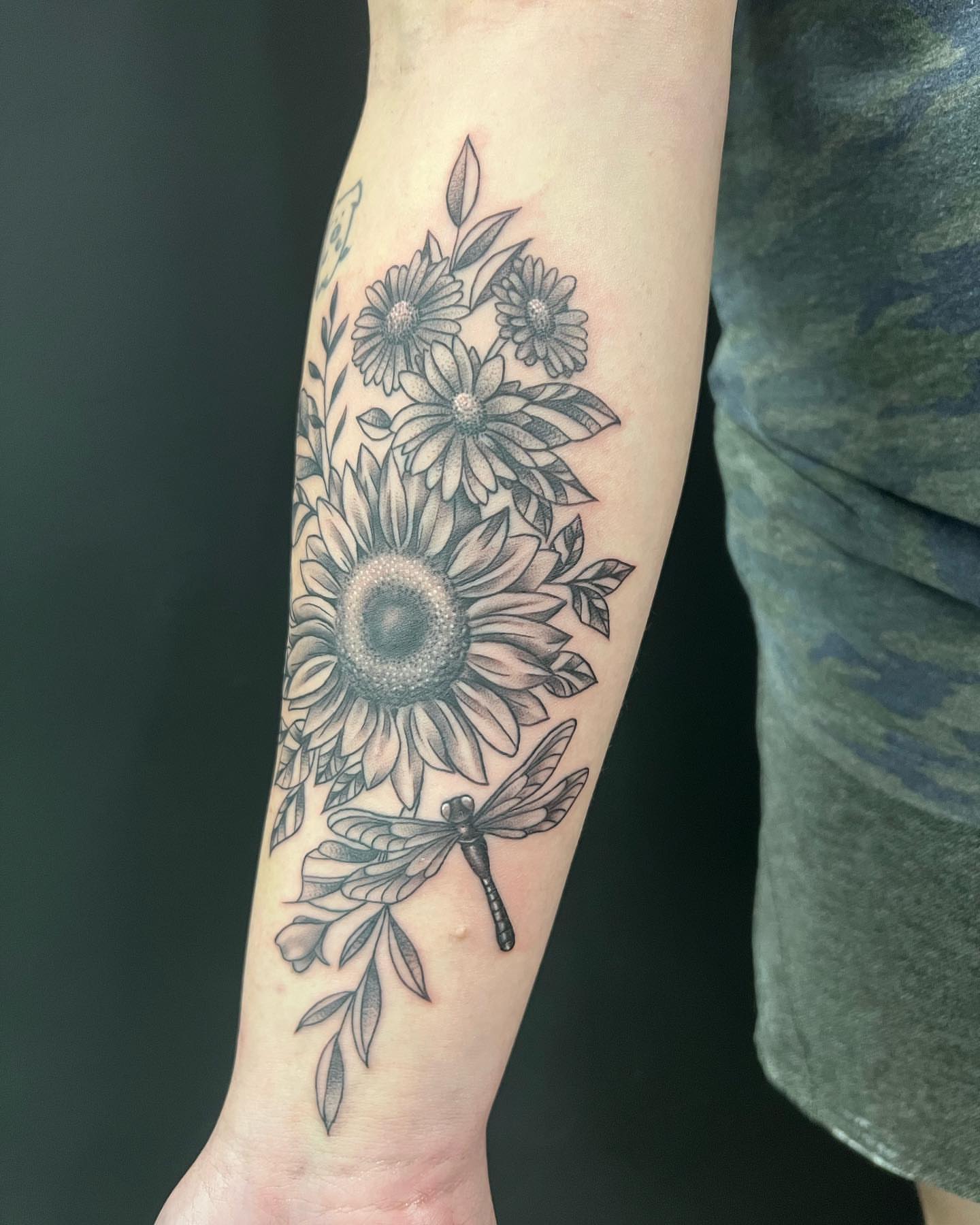 Sunflower bouquet with dragonfly realism tattoo on the forearm by CHiNO iNKs
