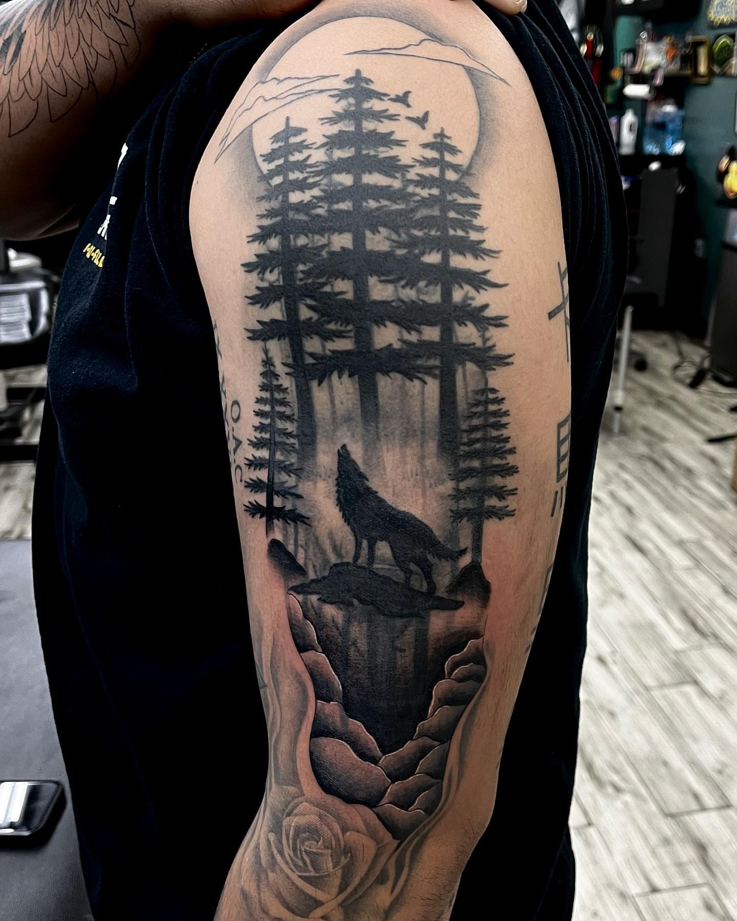 Wolf howling in forest realism tattoo on the forearm by Monique Ortiz, Mesa, Arizona