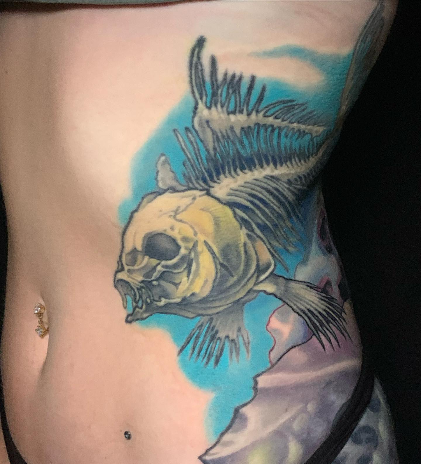 Fish skull realism tattoo on the torso by shane baker