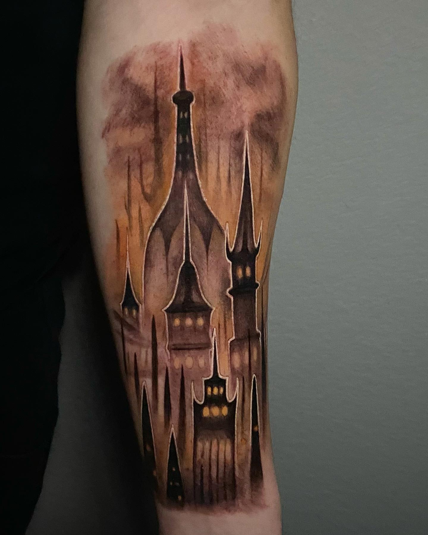 Castle silhouette watercolor tattoo on the forearm by Madison Ast Tattoo