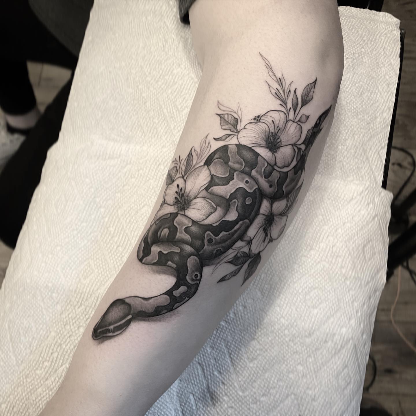Snake and flowers realism tattoo on the forearm by ⠀⠀ ⠀ ⠀ ⠀⠀ ⠀⠀ ⠀⠀ ⠀ ⠀⠀ ⠀⠀ᎪᎳᏃ, West Hollywood, California