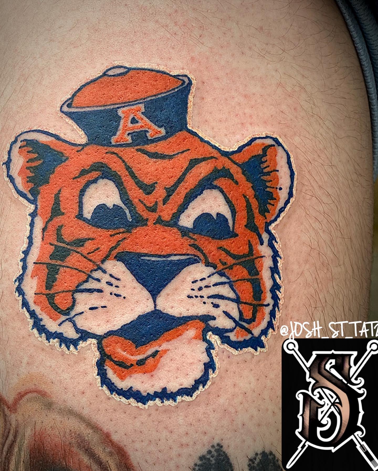 Tiger head American traditional tattoo on the thigh by Josh St.germain