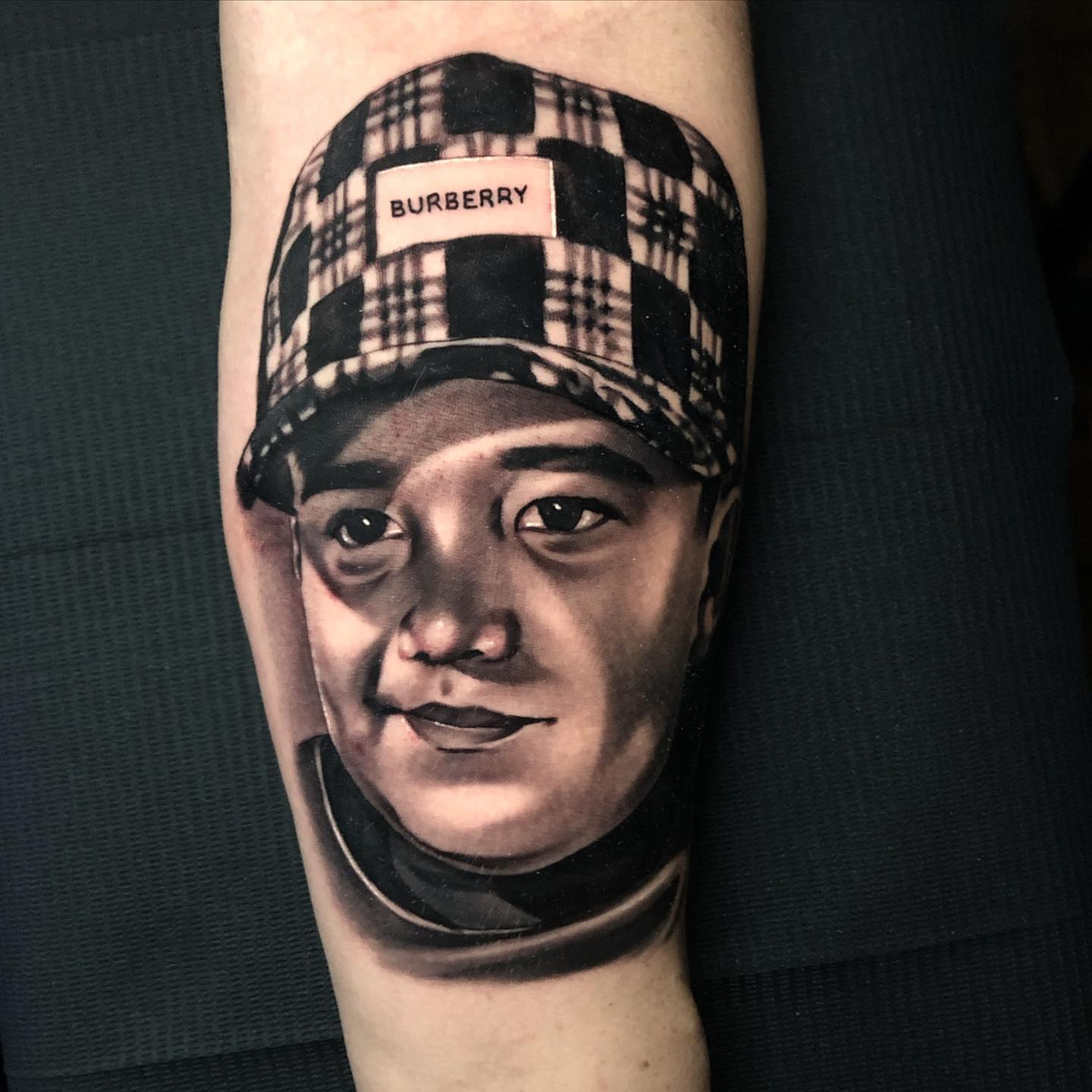 Plaid cap realism tattoo on the forearm by Michael Martinez