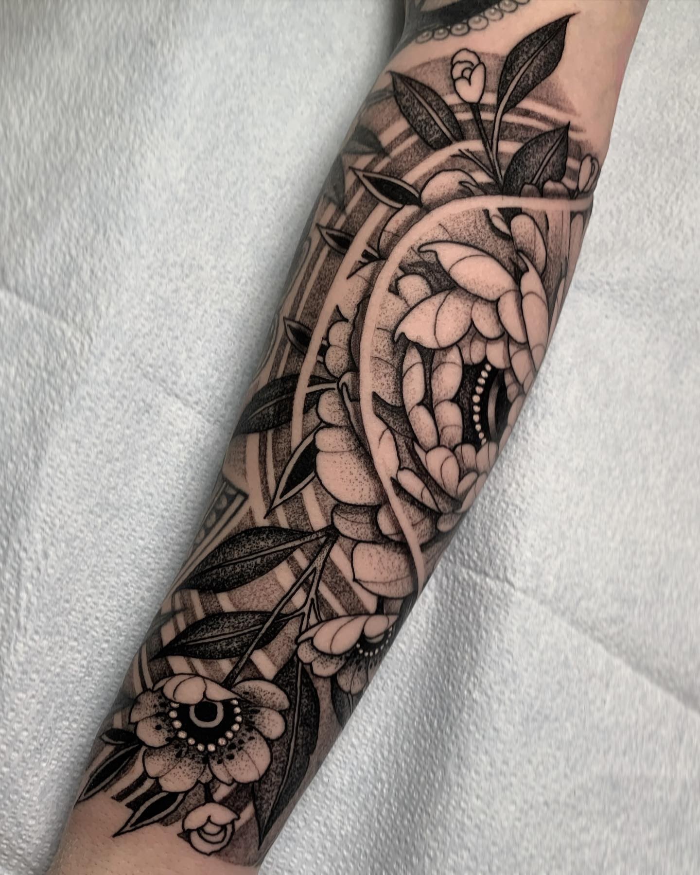 Snake and flowers dotwork tattoo on the forearm by Forrest Henderson 森