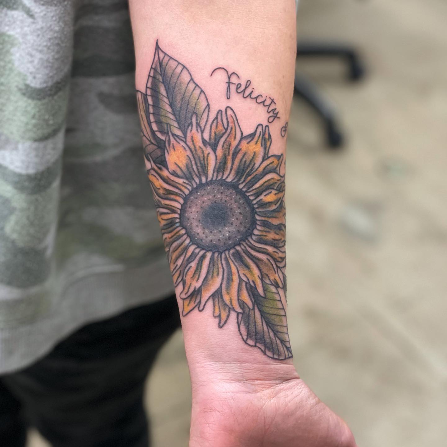 Sunflower dotwork tattoo on the forearm by Erin Stephens