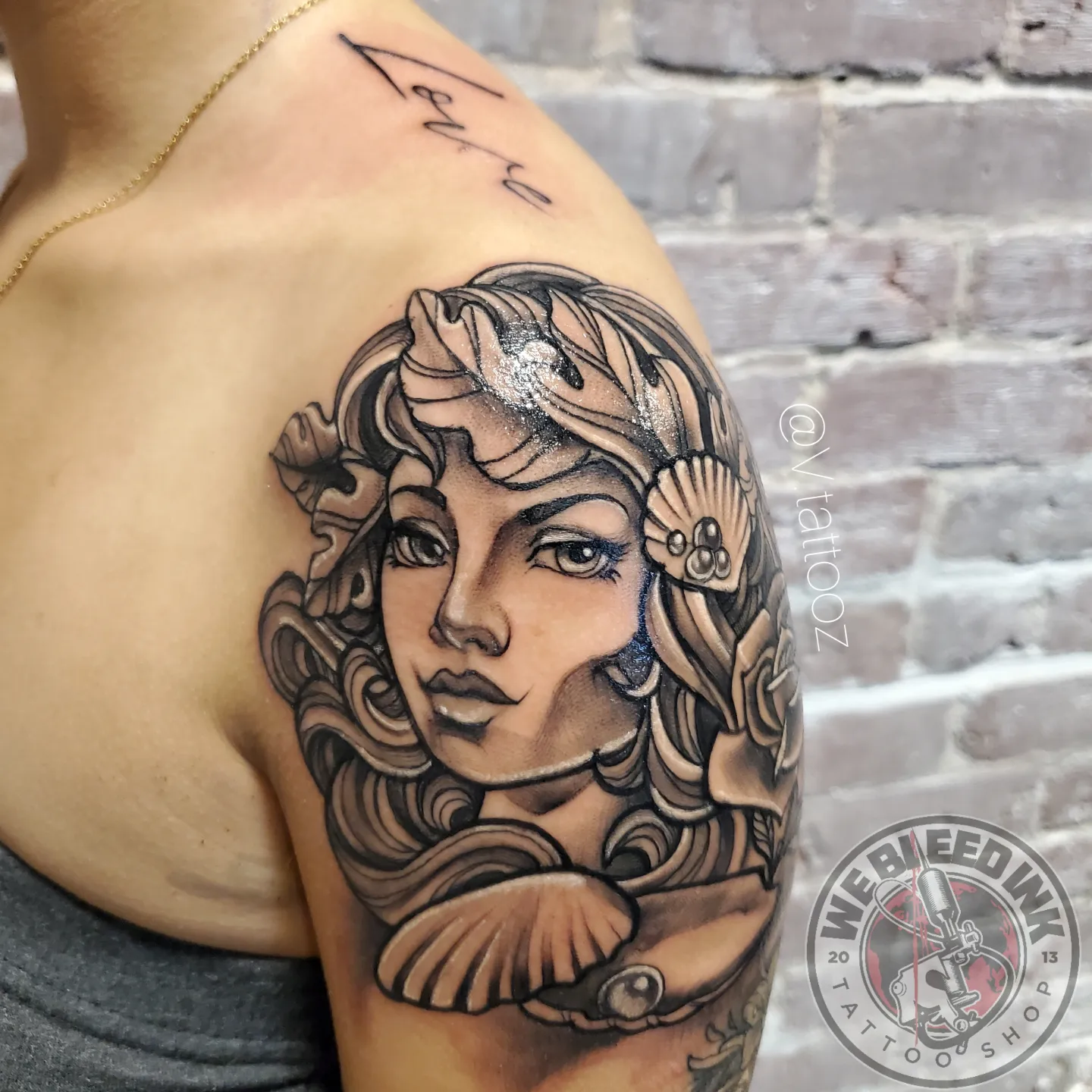 Woman's face realism tattoo on the shoulder by call (504)441-9275 for info