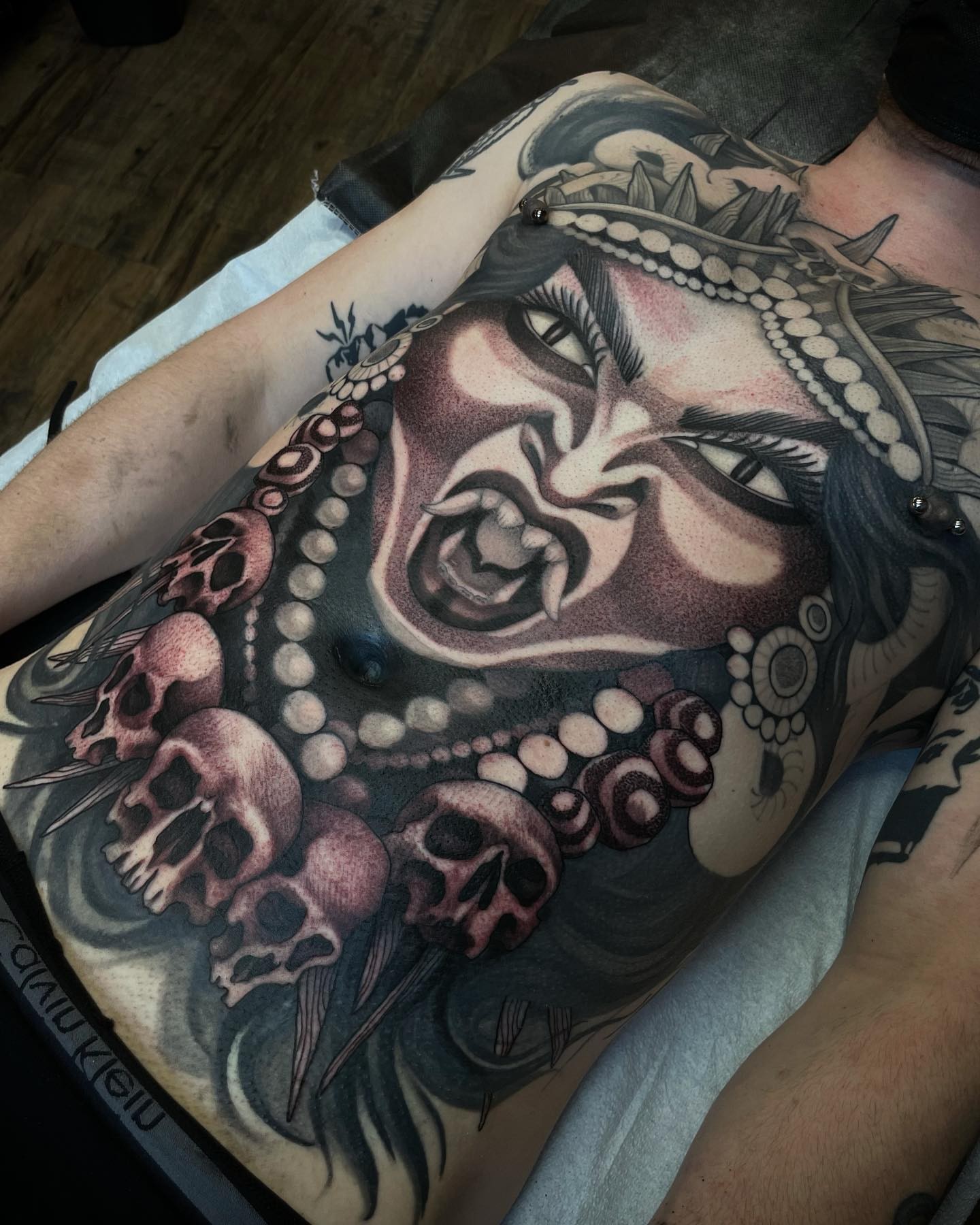 Woman with skulls realism tattoo on the thigh by gina