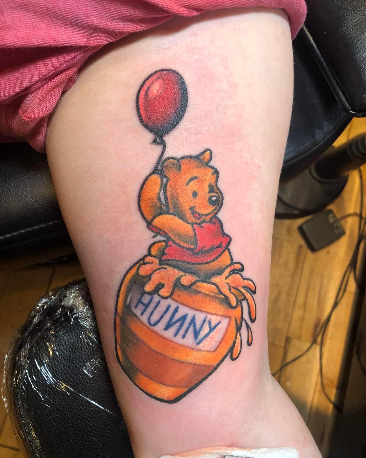 Winnie the Pooh illustrative tattoo on the thigh by A.W.