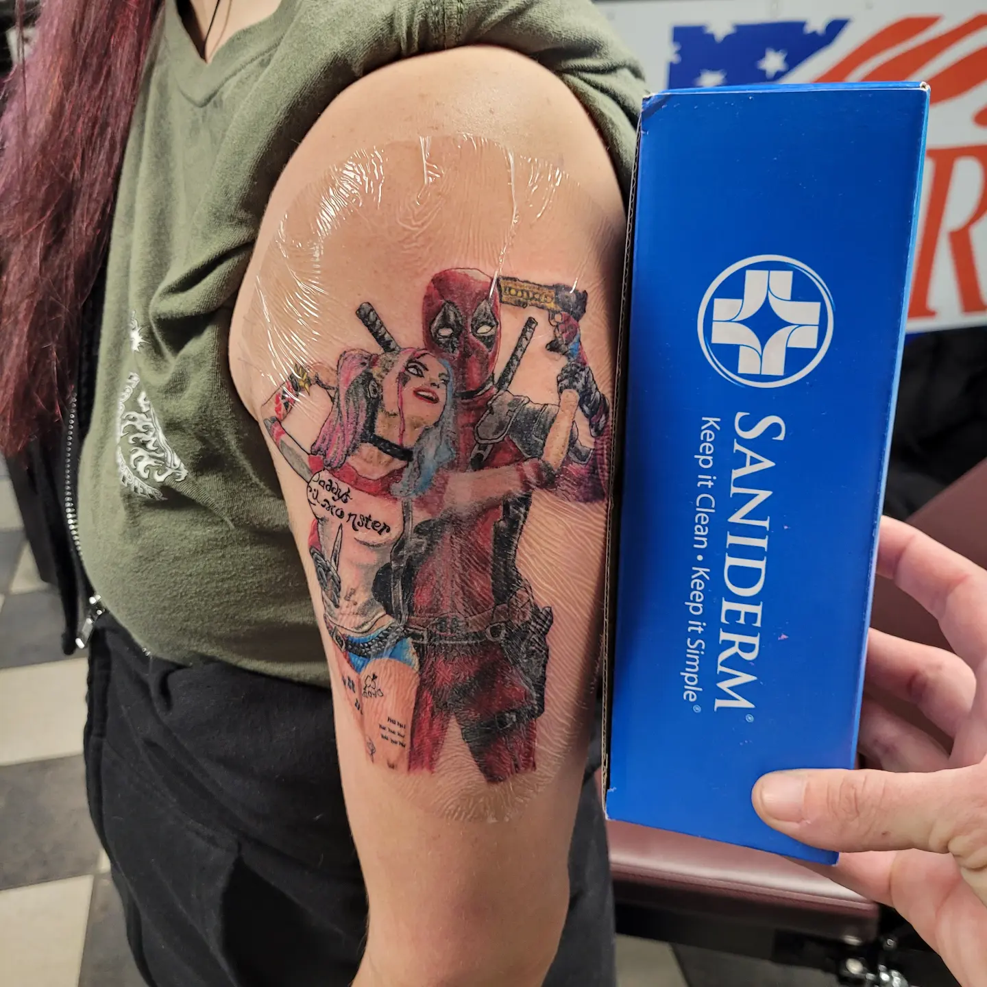 Deadpool and harley quinn realism tattoo on the forearm by Glen Wallis