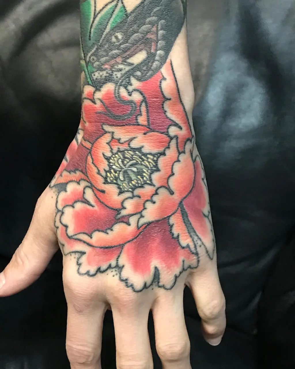 Peony American traditional tattoo on the hand by Brad Hill, Franklin, Tennessee