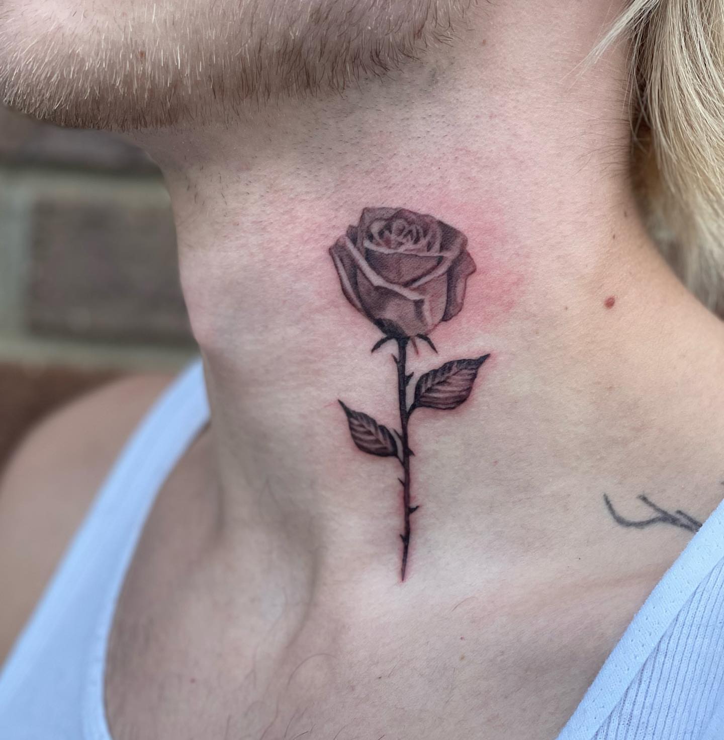 Rose black and grey tattoo on the neck by Jeremiah Warner