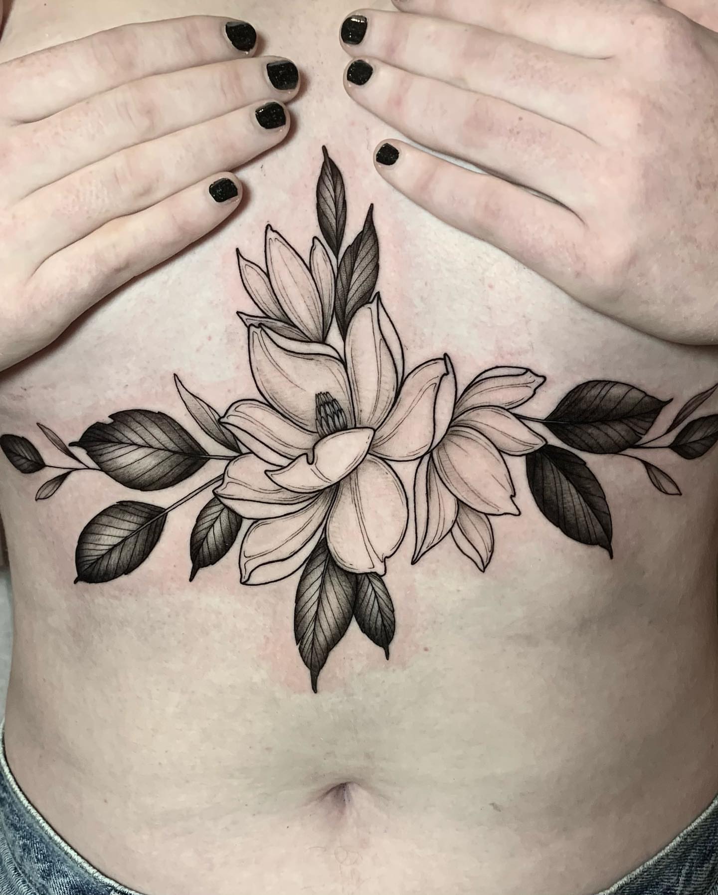 Magnolia flower black and grey tattoo on the ribs by Chelsea Darling