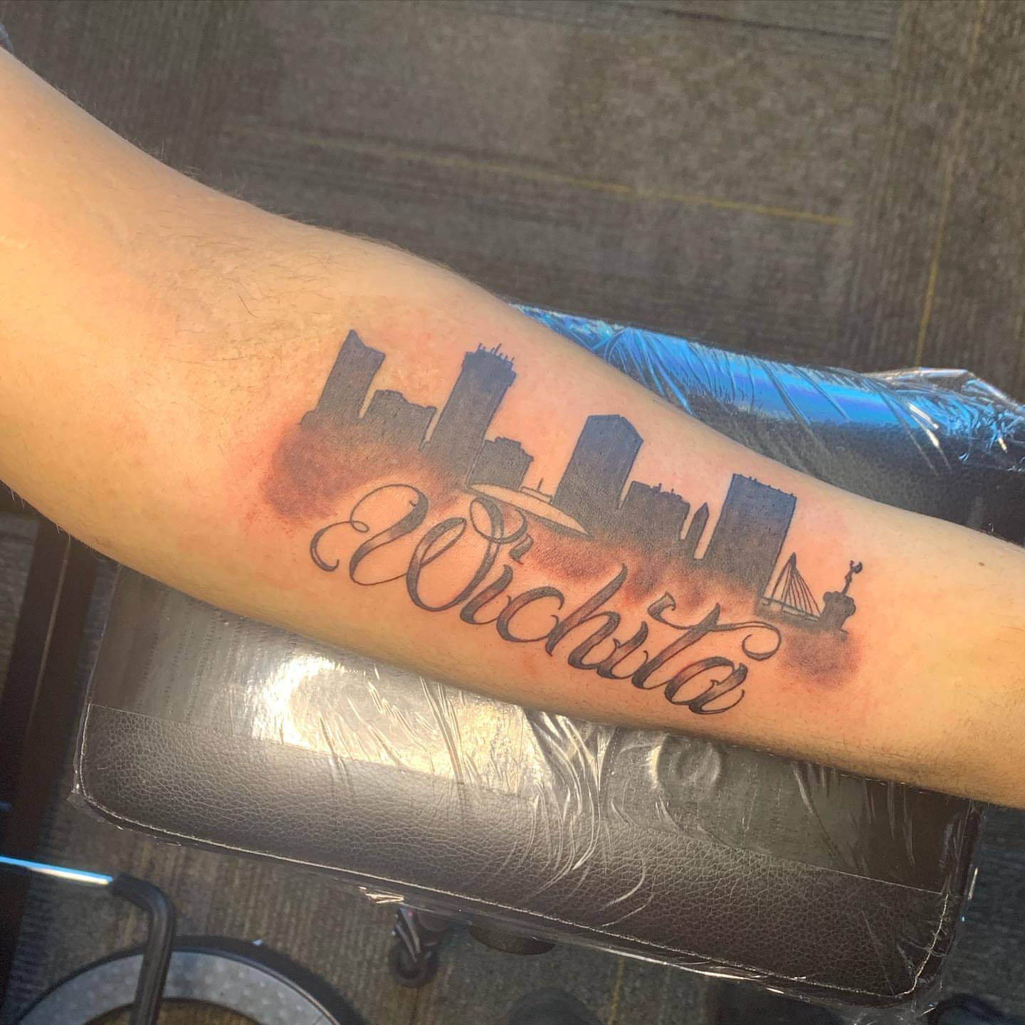Wichita skyline black and grey tattoo on the forearm by Wichita Tattoo
