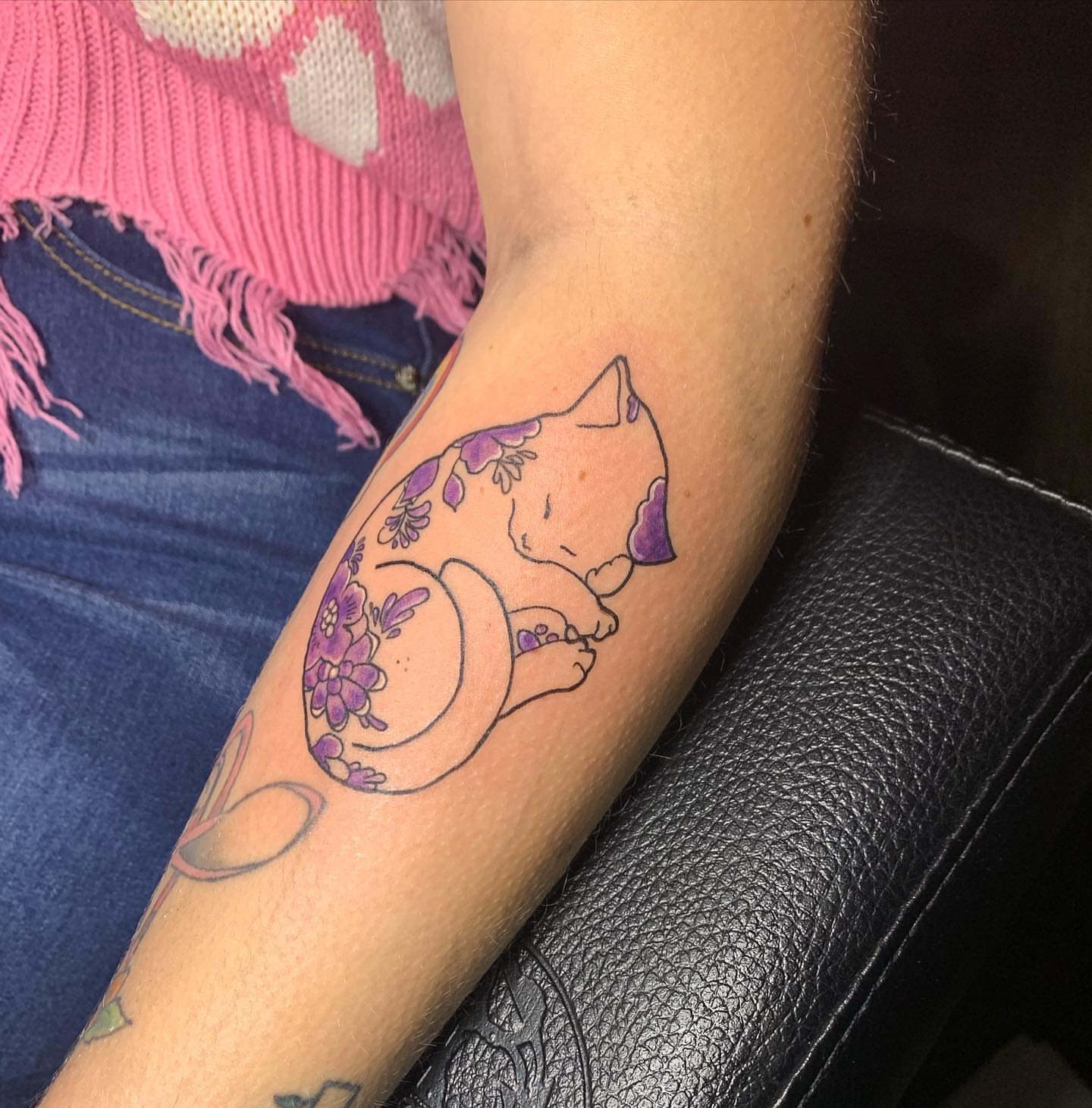 Cat with flowers new school tattoo on the forearm by Wichita Tattoo