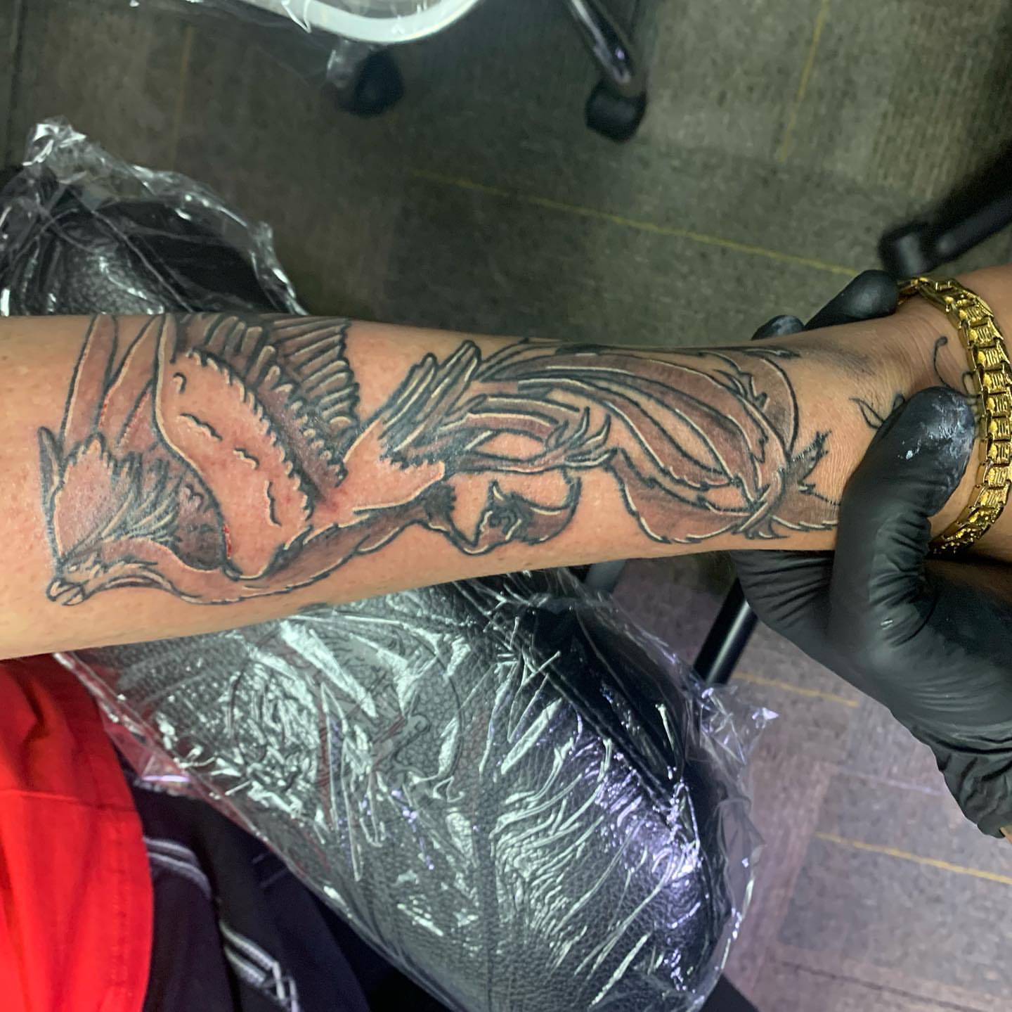 Phoenix American traditional tattoo on the forearm by Wichita Tattoo