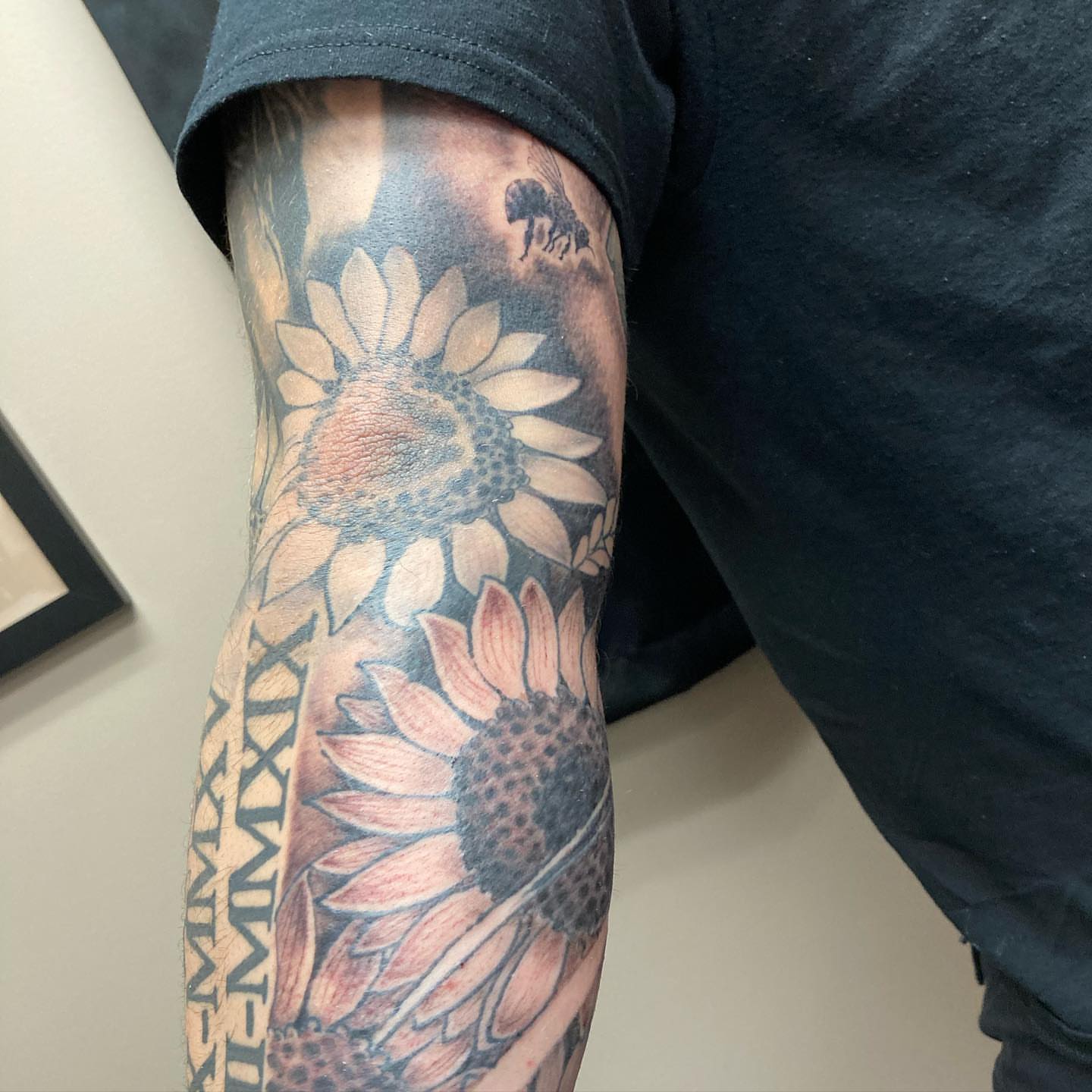 Sunflowers realism tattoo on the forearm by Chuck House