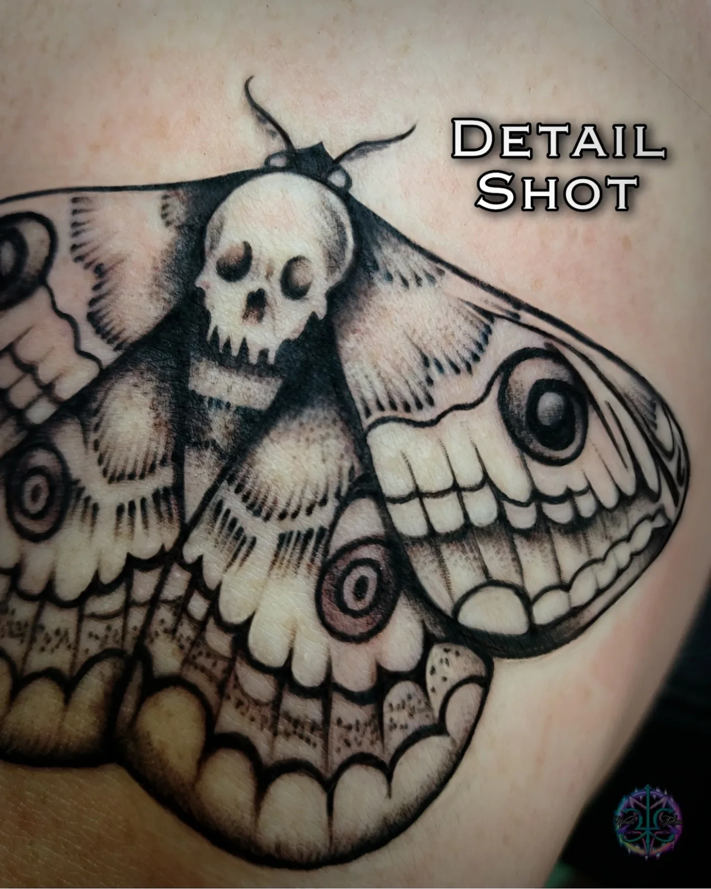 Moth with skull realism tattoo on the upper arm by Wendii Calderon
