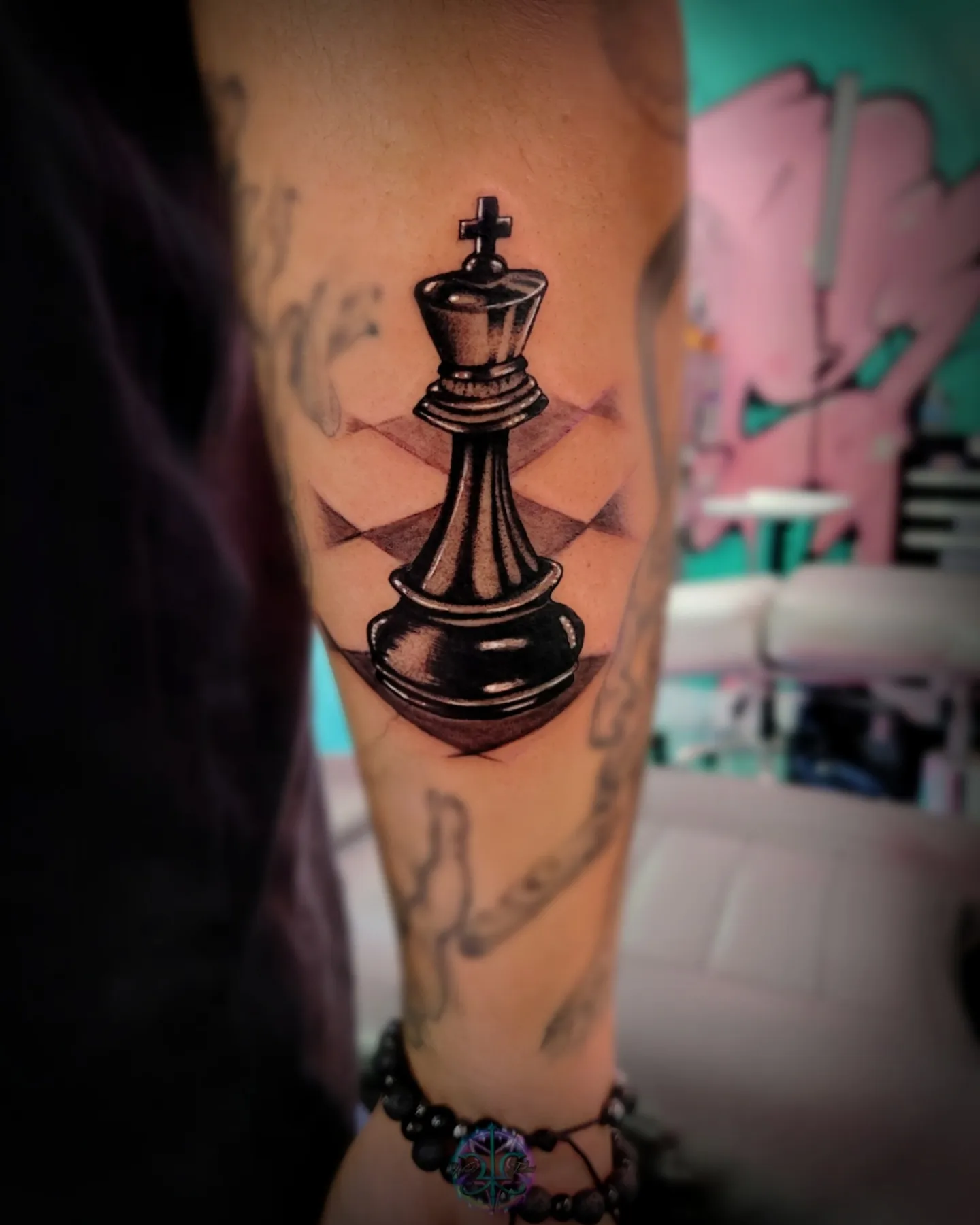 King chess piece black and grey tattoo on the forearm by Wendii Calderon