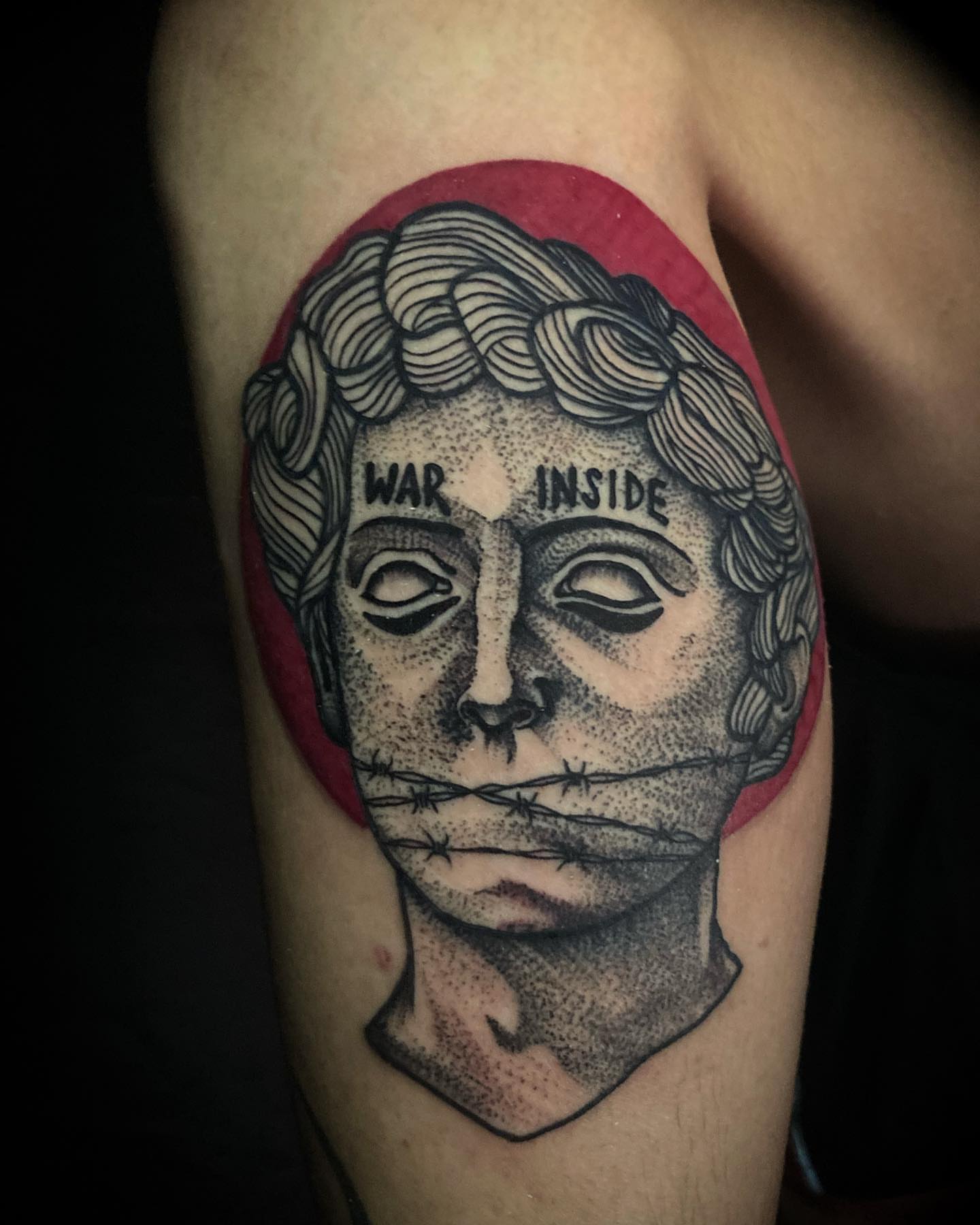 Statue head with barbed wire dotwork tattoo on the forearm by Adrian Gonzalez
